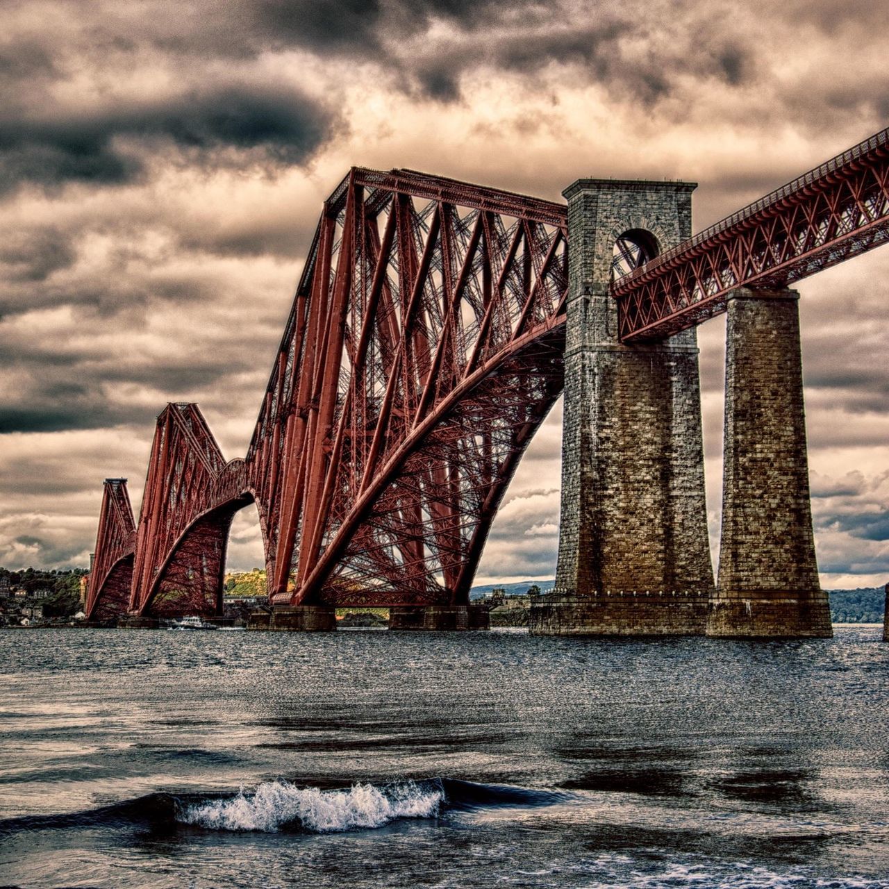 architecture, built structure, connection, bridge - man made structure, water, sky, engineering, cloud - sky, river, cloudy, waterfront, bridge, international landmark, famous place, travel destinations, suspension bridge, cloud, low angle view, tourism, travel