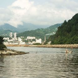 Scenic view of river with mountains in background