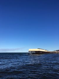 Scenic view of sea against clear blue sky