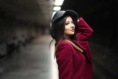 Portrait of a beautiful young woman standing outdoors