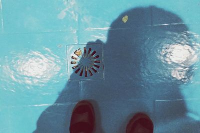 Low section of woman standing on tiled floor