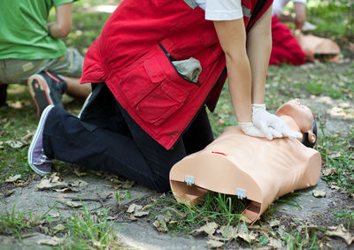 Low section of man and woman lying on field