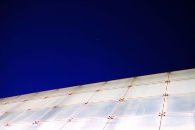 Low angle view of moon against blue sky