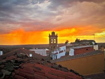 Scenic view of sea against cloudy sky during sunset