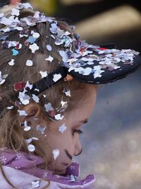 Close-up of girl covered in confetti