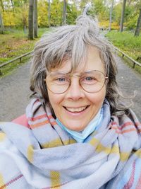 Portrait of smiling senior woman standing outdoors