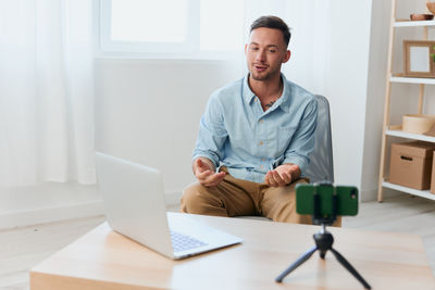 Portrait of young man working at office