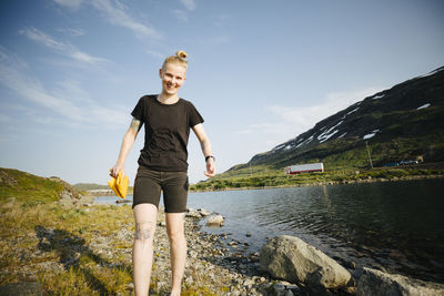 Smiling woman at lake in mountains