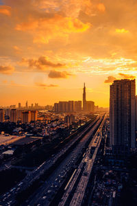 Aerial view of buildings against sky during sunset