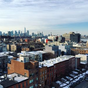 High angle view of cityscape against cloudy sky during winter