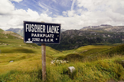 Information sign on landscape against sky