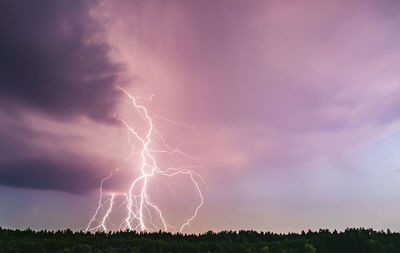 Low angle view of lightning against dramatic sky