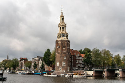View of building by trees against sky