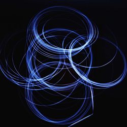 Light trails against black background