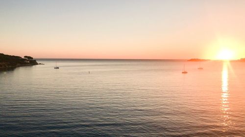 Scenic view of sea against clear sky during sunset