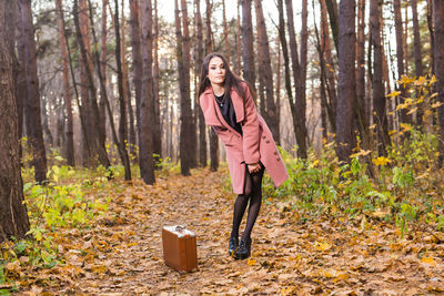 Full length portrait of woman in forest