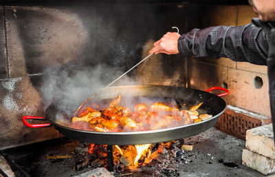 Midsection of man preparing food