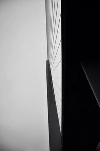 Low angle view of suspension bridge against sky