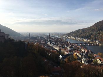 High angle view of townscape and mountains against sky