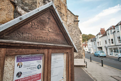 Information sign on street against buildings in city