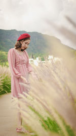 Woman standing on landscape against sky