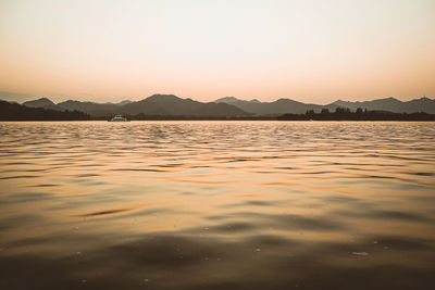 Scenic view of sea against clear sky during sunset