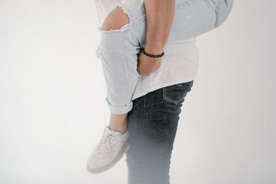 Rear view of woman standing against white background
