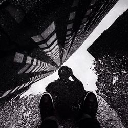 Low section of people standing in puddle