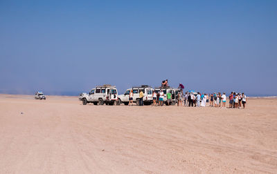 People and cars at desert