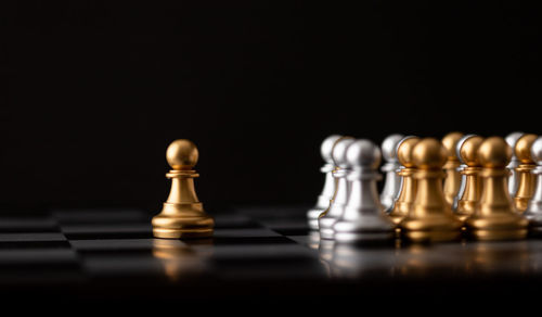 Close-up of chess pieces against black background