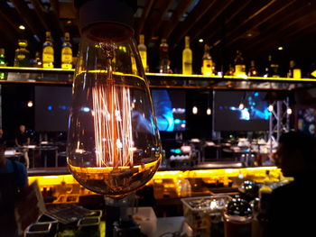 Close-up of wine glass bottles on table in restaurant