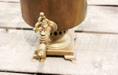 High angle view of metallic equipment on wooden table