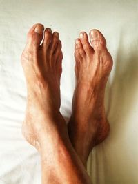 Low section of man legs on bed