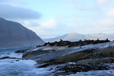 Scenic view of sea and mountains against sky