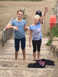 Portrait of friends standing on steps