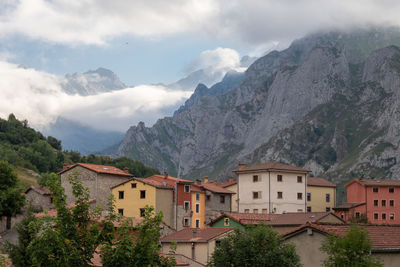 Panoramic view of buildings and mountains against sky