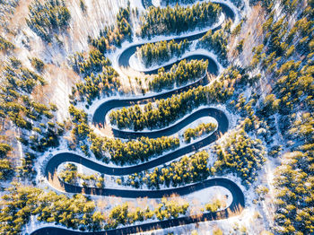 Aerial view of road amidst forest during winter