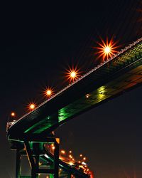 Low angle view of illuminated fireworks against sky at night