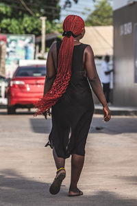 Rear view of woman walking on street in city