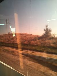 Scenic view of sunset seen through glass window