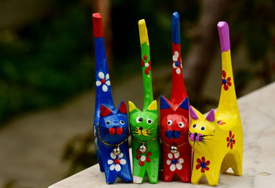 Hand made toys in intense colour yellow blue red green against flat colour background