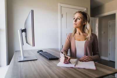 Young woman using laptop on table