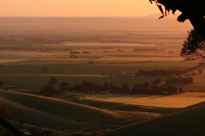 Scenic view of field against sky at sunset