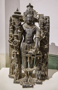 Buddha statue against historic building