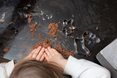 Cropped image of girl making gingerbread cookies