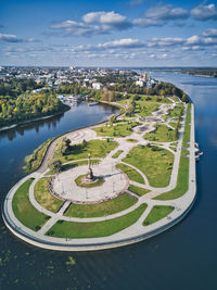 High angle view of city by sea against sky