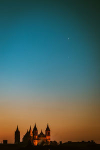 Silhouette church against clear sky at sunset