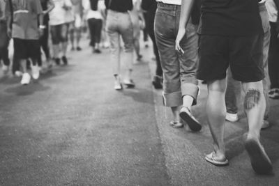 Low section of people walking on street