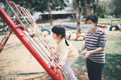 Side view of man standing in playground