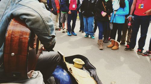 Low section of people standing on tiled floor